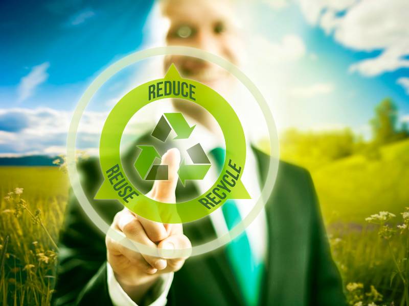 Hand touching a 'Reduce, Reuse, Recycle' icon with a green background.